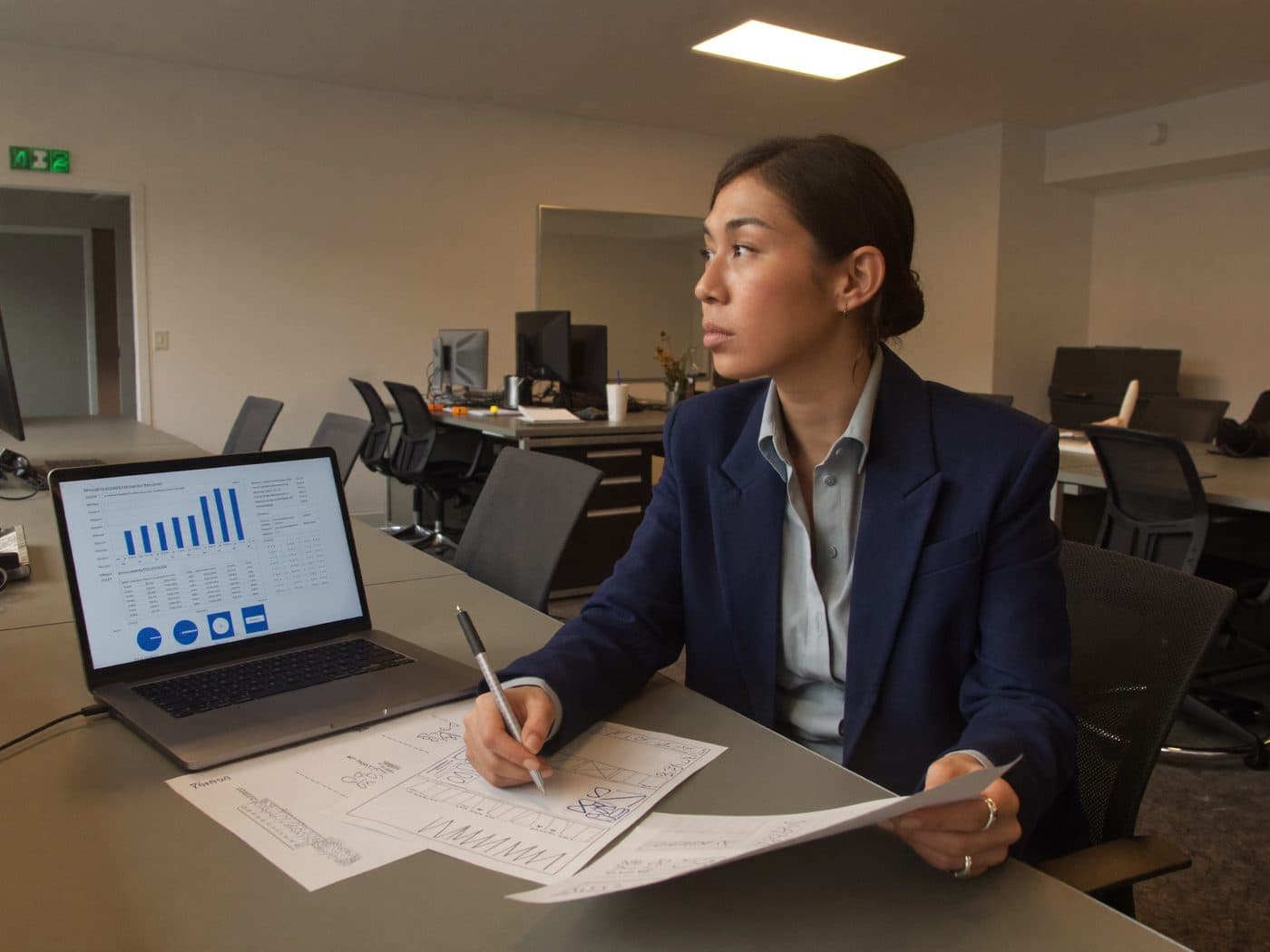 Accountant reviewing figures on a printed report at a desk