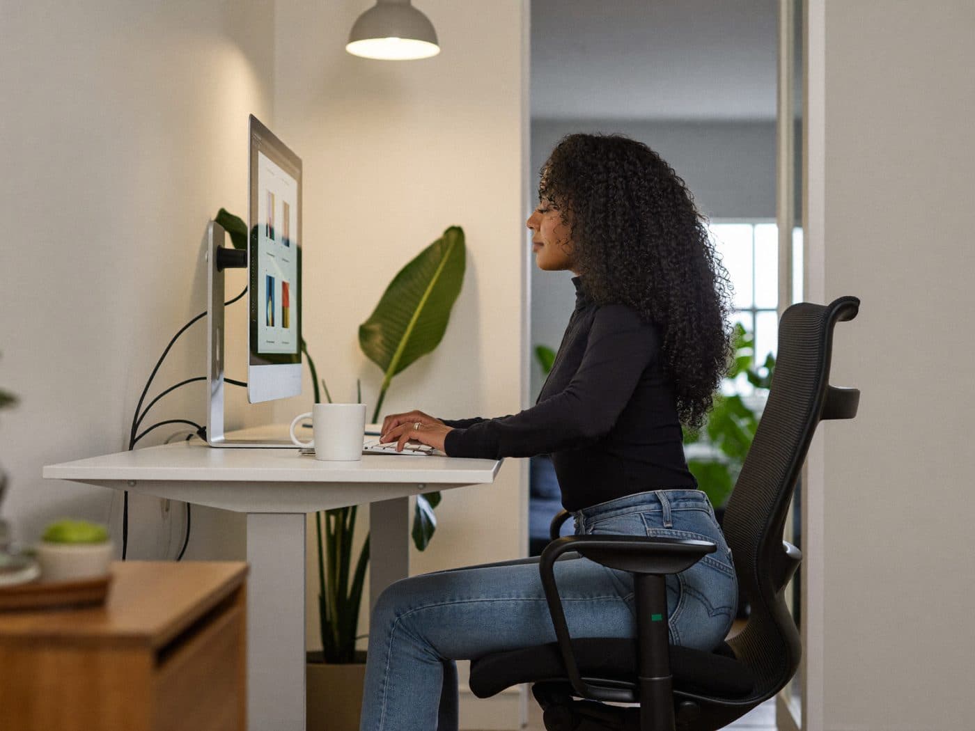 Remote developer on a video call with teammates from a home office